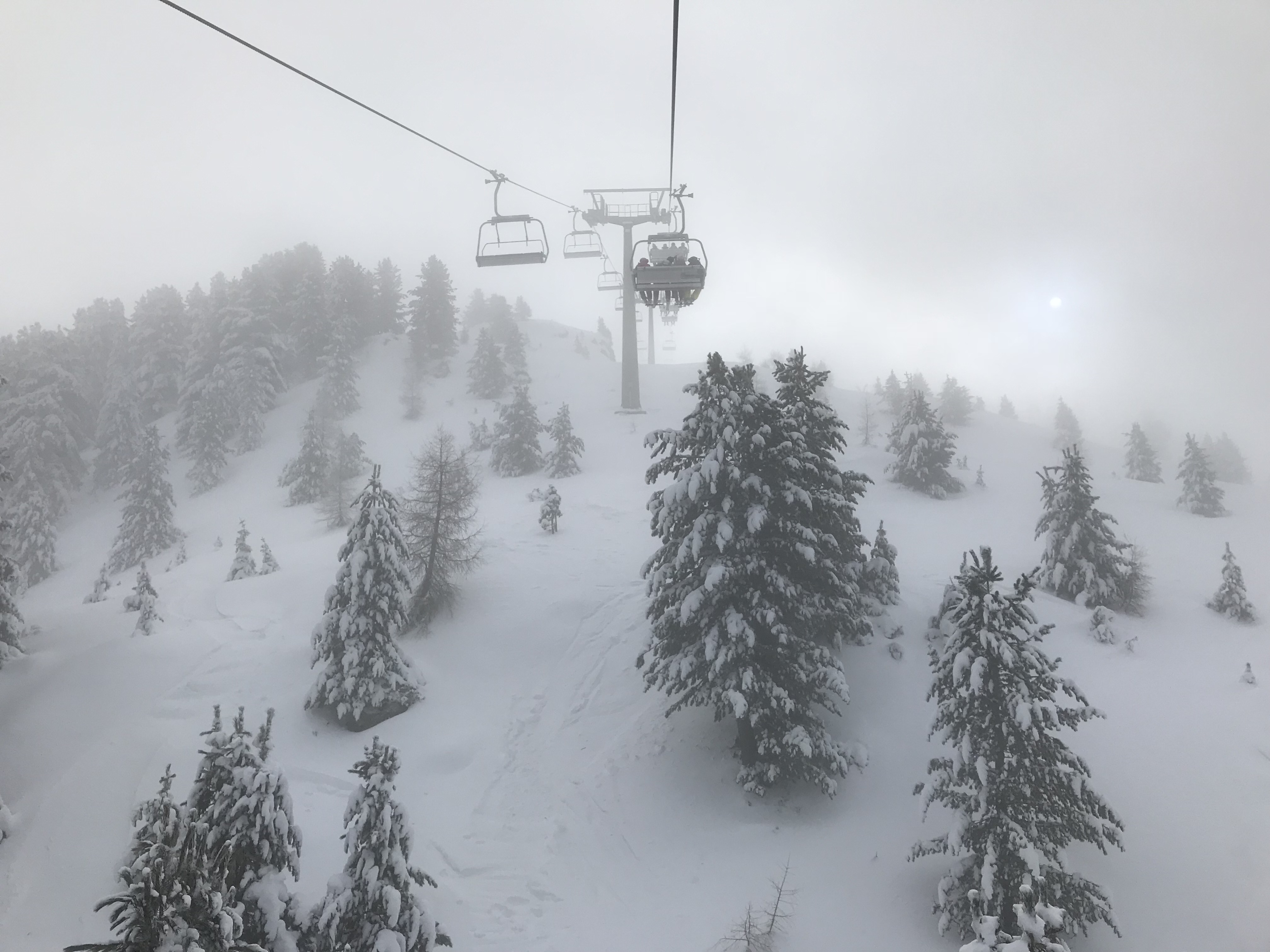 A lift up Ski Center Latemar in the middle of the clouds - Photo by The-Ski-Guru