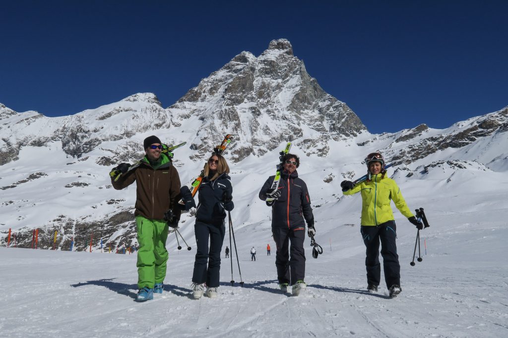 Skiers walking with the Monte Cervino in the backdrop. Photo Enrico Romanzi - Breuil Cervinia. How Italian Ski Resorts are preparing for the ski season.