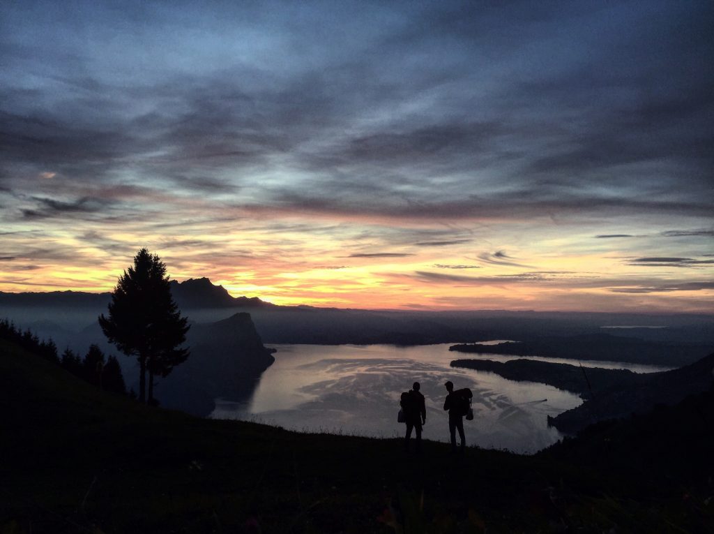 Some hikers in Lake Lucerne. Photo by Jon- Unsplash. NATURAL HAZARDS : Camping in Switzerland carries certain risks.