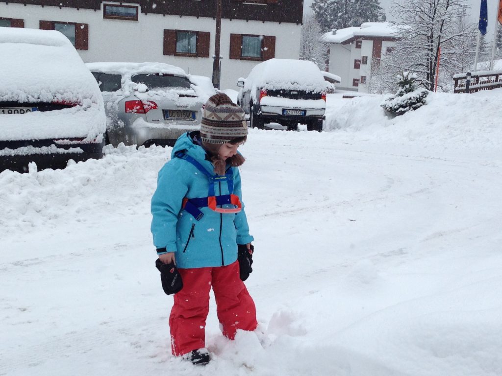 My youngest wearing his ski harness before going skiing in Madonna di Campiglio. 7 things that can help you when taking kids skiing.