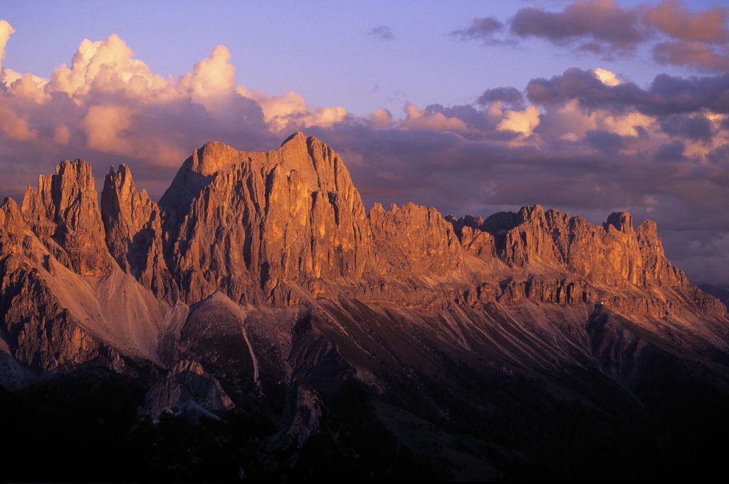 Copyright: IDM South Tyrol / Valentin Pardeller. The Dolomites are a UNESCO World Heritage Site. The rose garden glows impressively in the evening glow on the horizon of the regional capital of Bozen.A Must-Read Guide to Summer in South Tyrol.